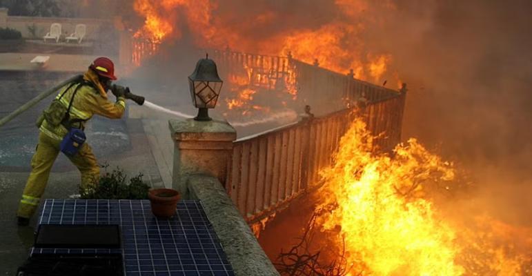 A firefighter battles flames during the September 2012 Shockey wildland fire near San Diego